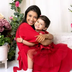 The bond between a mother and her child is pure magic. In this 'Mom & Me' session, we coordinated beautiful red outfits and used a floral backdrop to create a warm, love-filled portrait that feels timeless.