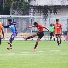 Another angle of a player striking the ball, demonstrating the technique we teach for effective shooting.