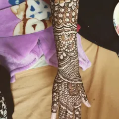 A gorgeous, detailed design for the bride's sister. It's intricate and provides significant coverage, making her feel just as special on the big day.