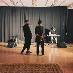 This image shows a moment of quiet collaboration during a session. Our studio is a versatile space that can host both high-energy activities and more focused, intimate creative work.
