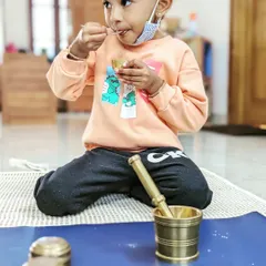There's immense pride in doing things for yourself. This child is enjoying a snack she prepared all on her own using a mortar and pestle, a perfect example of our practical life skills activities.