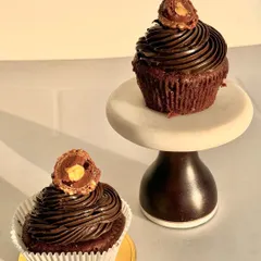 My Ferrero Rocher cupcakes are pure indulgence. They feature a rich chocolate cupcake base, a swirl of hazelnut frosting, and are topped with a whole Ferrero Rocher.