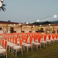 A large-scale outdoor Sangeet setup under the stars. The extensive string lighting and neat rows of chairs show the level of detail and organization that goes into planning for hundreds of guests.
