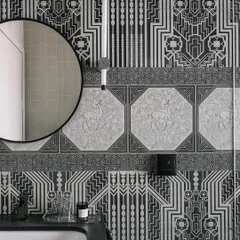 This black and white haven at Eden House feels like a warm hug for the soul. We used intricately patterned tiles and a custom wall light to create a cozy and stylish bathroom.