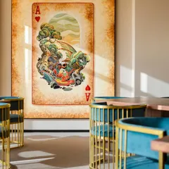 A large, custom art piece depicting an Ace of Hearts adds a playful and surreal touch to this lounge area. Art is used here not just as decor, but as a conversation starter and a central feature that gives the space its unique character.