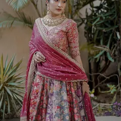 A beautiful outdoor shot of the floral lehenga. The natural light brings out the rich colors of the fabric and the intricacy of the embroidered blouse.