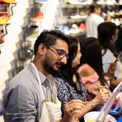 A participant at the Adidas event, completely focused on his artwork. We love creating unique experiences that align with a brand's identity.