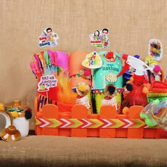 A fun and playful Holi gift set, complete with water guns and snacks, photographed for a festive e-commerce product listing.
