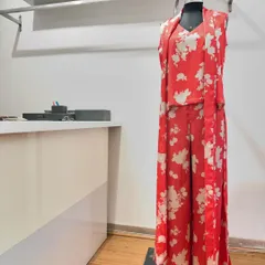 This alluring red floral print satin co-ord set is a showstopper. The set includes a sleeveless top, matching trousers, and a longline jacket, offering a complete and polished look for any event.