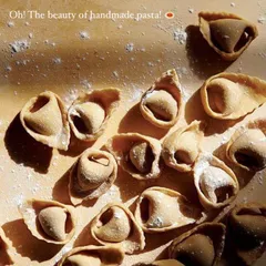 The beauty of handmade pasta is in the details. Look at these perfectly folded tortellini, ready to be cooked. You can see the texture of the fresh dough.