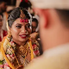 A close-up of the bride's beautiful expression as she looks at her groom during the wedding ceremony, a candid moment full of love.