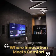 This modern living space combines a bar area with a home entertainment system. We installed in-wall speakers and a large screen, complemented by custom zigzag ceiling lights, to create a multi-functional room for relaxation and socializing.