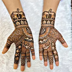 This design is perfect for a guest or a festival, featuring a prominent elephant motif. The patterns are dense on the hand but stop at the wrist, making it a statement piece that isn't as extensive as a full bridal design.