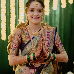 The bride in her multi-toned Paithani saree, ready for another ceremony. The makeup is soft and glowing, with a neutral lip to let the beautiful colors of the saree shine.
