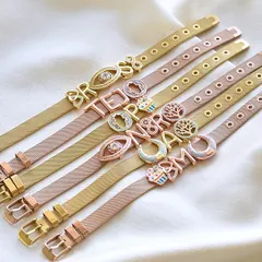 Your watch deserves a friend. Our customizable watch belt bracelets come in gold and rose gold, ready for you to add your initials and favorite charms like the evil eye, moon, or cupcake.