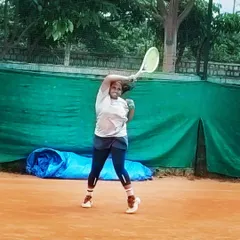 A female player unleashes a powerful overhead shot during the Tennis360 TS7 AITA U-14 tournament.