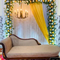 A closer look at the elegant ring ceremony decor, highlighting the intricate floral work and the warm light from the chandelier creating a perfect ambiance.