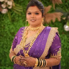 A beautiful moment of a bride on her wedding day, adorned in a purple Paithani saree. I created a classic look for her, complete with the traditional 'mundavalya' forehead ornament.