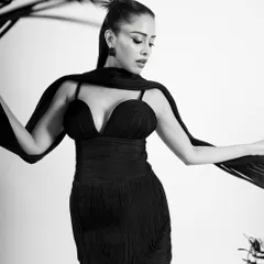 A beautiful shot that plays with the flowing scarf, creating elegant shapes and lines in monochrome.