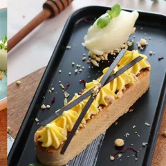 This dessert shot focuses on elegance and detail. The sharp lines of the pastry, the piped cream, and the delicate chocolate garnishes are all captured with precision to showcase the chef's artistry.