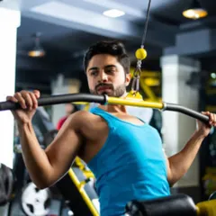 The lat pulldown is a key exercise for developing a wide, strong back. Proper form involves pulling the bar to the chest while keeping the torso upright to maximize lat engagement.