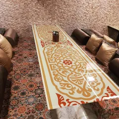 A close-up of the beautifully designed low table in my Dastarkhwan area. The intricate patterns and comfortable seating make every meal feel like a special occasion.