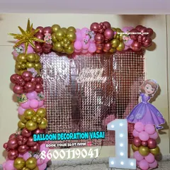 A royal celebration with a Princess Sofia theme. The decor includes a rose gold shimmer wall, a pink and chrome balloon frame, and a character cutout.