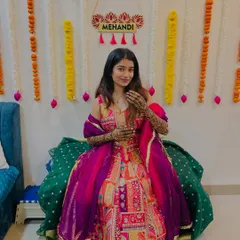 The lovely Shrutika at her mehendi ceremony. She looks radiant and happy, and her colorful outfit perfectly complements the rich tones of her henna.