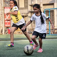 Football is for everyone. Here, two of our young players are engaged in a friendly drill, showcasing the supportive and inclusive environment we foster, especially in our dedicated all-girls batches.