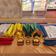 The rewards of dedication. Belts, trophies, and certificates are ready for our students at the belt promotion ceremony. Each one is earned through hard work.