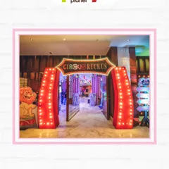 The grand, brightly lit entrance to a "Circus Ruckus," inviting guests into a world of fun and excitement.