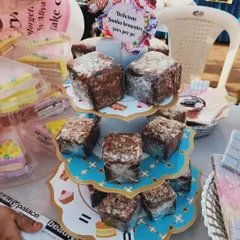 My jumbo brownies displayed on a tiered stand at a carnival. Each piece is individually wrapped, making them a great grab-and-go treat for your guests.
