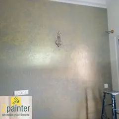 A sophisticated wall finish using a metallic glaze over a grey base. This technique results in a soft, shimmering texture that changes depending on the light, adding a touch of understated glamour.
