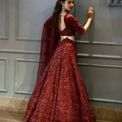 The deep bordeaux tone of this lehenga is just stunning. Fully embellished with sequins, it's a glamorous choice for a reception or evening wedding event.