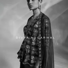 An artistic black and white portrait showcasing an embellished peplum top. This style of photography allows the intricate details and modern silhouette to take center stage.