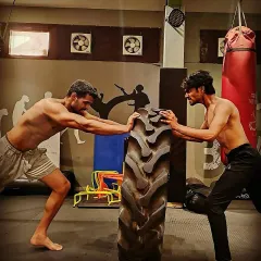 Strength isn't just for show; it's for survival. In my combat fitness sessions, we build functional power with drills like tire flips that prepare your body for the explosive demands of a real fight. This is how you become a harder target.