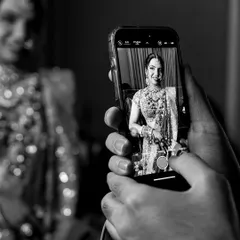 Capturing the final look on my phone. This black and white shot shows a behind-the-scenes moment of me documenting the bride's complete look before she steps out.