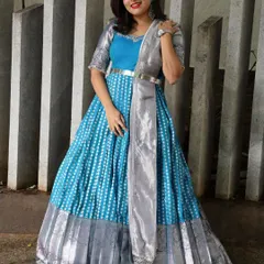A full-length shot of a beautiful blue and silver Anarkali-style gown, a modern take on a traditional classic.