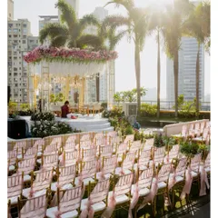 The stunning rooftop mandap setup at the St. Regis Mumbai for a 50th-anniversary celebration, with the city skyline in the background.