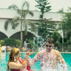 The pure, uninhibited joy of a Haldi ceremony, captured as the couple playfully splashes in a pool. I believe in capturing the real fun, those unscripted moments that become the best memories.