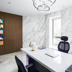 A director's cabin should feel both powerful and personal. For the 'Greywood Loft', I combined a sleek white desk with a backdrop of rich wood paneling and textured marble walls to create a space of sophisticated authority.