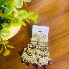 These limited edition tiered chandbalis are perfect for the wedding season. The combination of kundan work with deep purple beads creates a royal look that will definitely get you noticed.