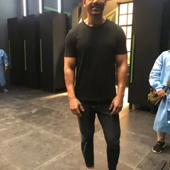 John Abraham styled in a simple, athletic look featuring a black t-shirt and joggers. This showcases my ability to create authentic and comfortable looks for fitness-oriented shoots.