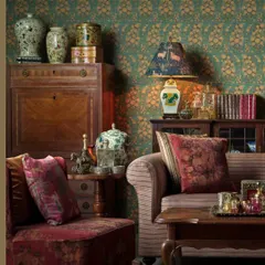 A living room setting showcasing Sabyasachi's artful blend of patterns and textures. The wallpaper, sofa upholstery, and cushions all come together to create a rich, layered, and distinctly Indian luxury aesthetic.