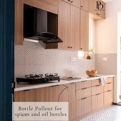 A slim bottle pull-out cabinet next to the stove is a game-changer for Indian kitchens. It keeps everyday oils, sauces, and spices organized and within easy reach while cooking.
