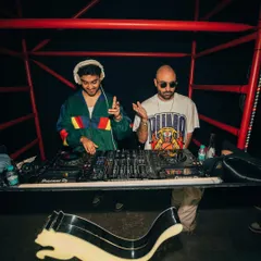 Spinning alongside a fellow artist at a high-energy event for Puma. The red lighting and prominent logo created a bold, dynamic atmosphere for the night.