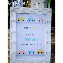 A light-up welcome sign for Nirav's first birthday, designed with a cute and simple car theme.