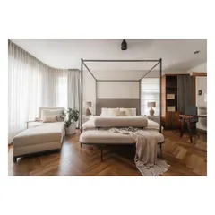 A full view of the master suite, showcasing the four-poster bed, a comfortable chaise lounge for reading, and an integrated workspace.