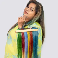 I'm holding a hanger of our vibrant Colour Strands. From green and red to blue and yellow, you can choose any color to match your mood or outfit, all without damaging your hair.