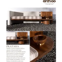 This 'Prataha' daybed is crafted for relaxation, blending Balharsha teakwood with a sleek micro-concrete finish. Brass metal joints ensure durability, while a handcrafted wooden bowl with chiseled patterns adds an artisanal touch.
